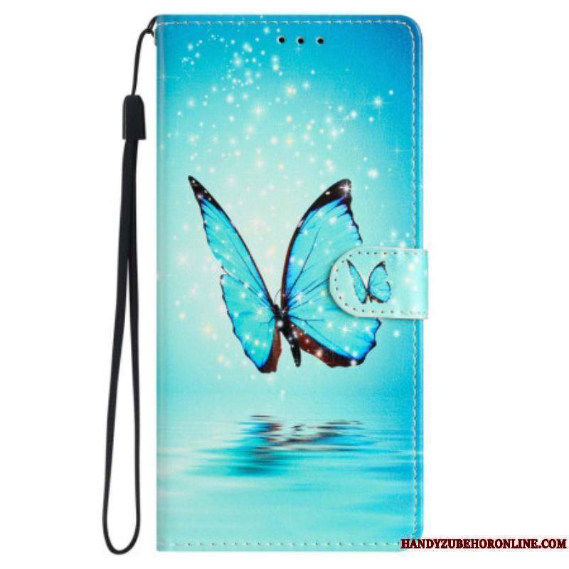 Housse iPhone 15 Papillon Bleu en Vol à Lanière